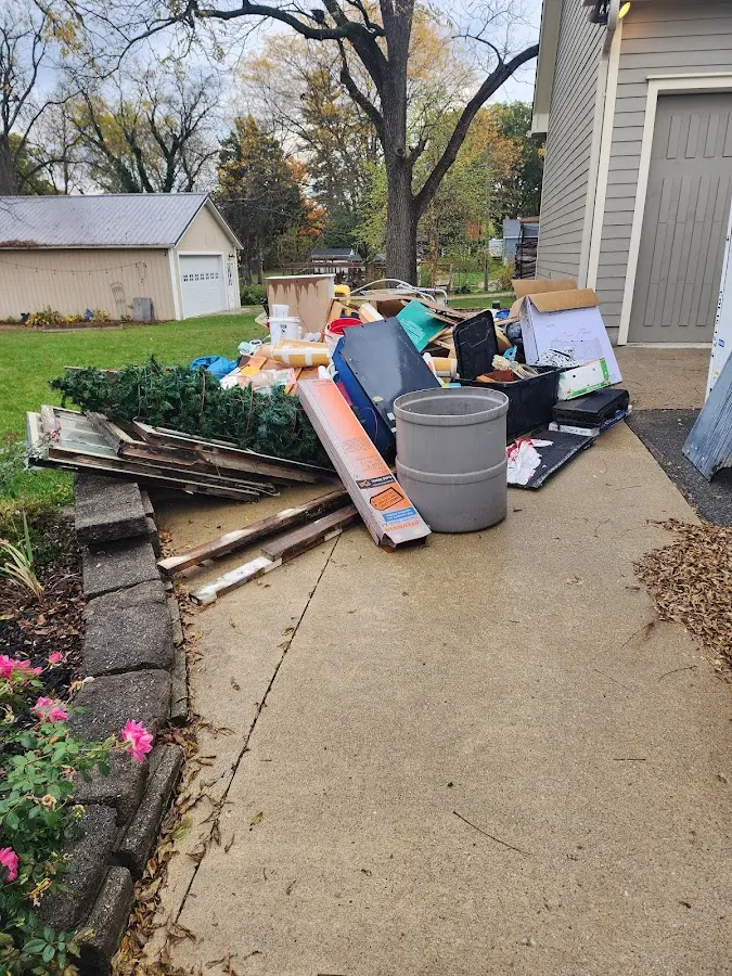 Dumpster being loaded with debris for Commercial Dumpster Rental in Delta